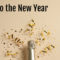 The top of a champagne bottle with glitter and streamers flowing out from it. The logo of FBN and the words "Cheers to the New Year" sit in opposite corners.